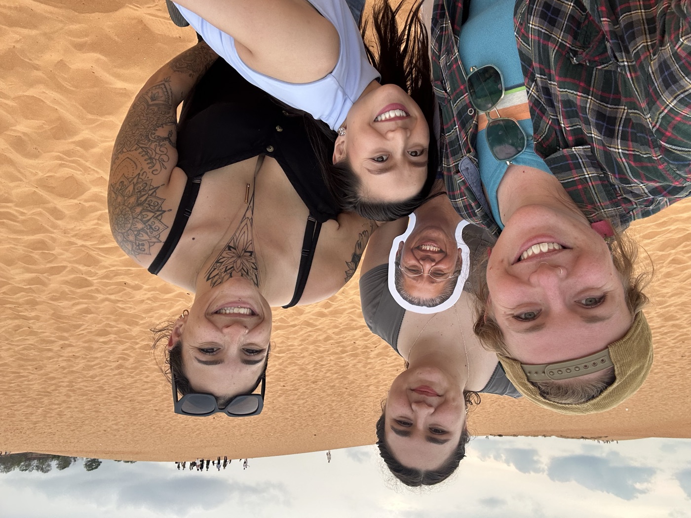 Team members together at the red sand dunes